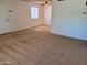 The open living room features neutral carpet flooring and a bright window, creating a welcoming atmosphere at 700 W University Dr # 203, Tempe, AZ 85281