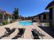 Community pool surrounded by residential buildings. Lounge chairs for relaxation. Perfect for summer at 700 W University Dr # 203, Tempe, AZ 85281
