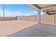 Spacious backyard featuring a covered patio and a brick wall for privacy at 7420 S 76Th Ln, Laveen, AZ 85339