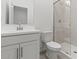 Bright bathroom with a modern vanity, toilet, and walk-in shower at 7420 S 76Th Ln, Laveen, AZ 85339