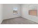 Clean, minimalist bedroom with neutral carpet and a bright window view at 7420 S 76Th Ln, Laveen, AZ 85339