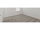 Neutral bedroom featuring soft, neutral carpet, and a window providing natural light at 7420 S 76Th Ln, Laveen, AZ 85339