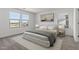 Bright bedroom featuring three large windows, neutral decor, and plush bedding at 7420 S 76Th Ln, Laveen, AZ 85339
