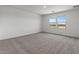 Expansive bedroom featuring soft carpet, bright windows, and mountain views at 7420 S 76Th Ln, Laveen, AZ 85339