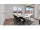 Dining area with a modern table set, sliding glass doors, and view of the fenced yard at 7420 S 76Th Ln, Laveen, AZ 85339