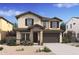 Charming two-story home featuring stone accents and a covered entryway, enhancing curb appeal at 7420 S 76Th Ln, Laveen, AZ 85339