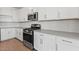 Well-appointed kitchen featuring stainless steel appliances, gray countertops, and ample white cabinets at 7420 S 76Th Ln, Laveen, AZ 85339