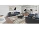 Open-concept living room with modern decor and a seamless view into the kitchen at 7420 S 76Th Ln, Laveen, AZ 85339