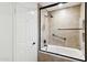 Bathroom features a bathtub shower combination, handrails and a glass shower door at 8405 E San Pedro Dr, Scottsdale, AZ 85258