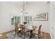 Well-lit dining room with a wooden table, stylish rug, and elegant light fixture with lots of natural light at 8405 E San Pedro Dr, Scottsdale, AZ 85258