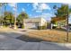 Beige home with a two-car garage and lush landscaping, complete with a beautiful lawn at 8405 E San Pedro Dr, Scottsdale, AZ 85258