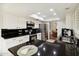 Spacious kitchen with stainless steel appliances, a skylight, and dark granite countertops at 8405 E San Pedro Dr, Scottsdale, AZ 85258