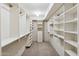 Spacious walk-in closet provides ample storage with built-in shelving and drawers at 8405 E San Pedro Dr, Scottsdale, AZ 85258