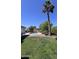 Backyard with a pool, palm trees, and grassy area at 8618 N 45Th Dr, Glendale, AZ 85302