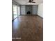 Large living room featuring a fireplace, ceiling fan, and sliding glass door at 8618 N 45Th Dr, Glendale, AZ 85302