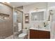 Elegant bathroom with a tiled glass shower, modern vanity, and decorative elements at 8701 E Sage Dr, Scottsdale, AZ 85250