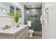 Stunning bathroom features a dual sink vanity, glass shower with vertical tile and designer touches at 8701 E Sage Dr, Scottsdale, AZ 85250