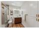 Stylish bathroom featuring a glass shower, modern vanity, and wood-look flooring at 8701 E Sage Dr, Scottsdale, AZ 85250