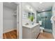 Bathroom featuring double sink vanity and glass enclosed blue-tiled shower at 8701 E Sage Dr, Scottsdale, AZ 85250