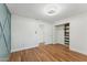 Spacious bedroom featuring hardwood floors, modern lighting and a custom closet at 8701 E Sage Dr, Scottsdale, AZ 85250