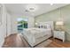 Bright bedroom with a plush bed, stylish accent wall, and sliding glass door to the backyard at 8701 E Sage Dr, Scottsdale, AZ 85250