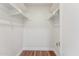 Walk-in closet featuring modern hanging rods and hardwood floors at 8701 E Sage Dr, Scottsdale, AZ 85250