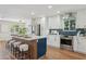 Bright kitchen featuring white cabinets, quartz countertops, stainless steel appliances, and a stylish island at 8701 E Sage Dr, Scottsdale, AZ 85250