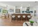 Modern kitchen with white cabinets, stainless steel appliances, a unique island, and wood flooring at 8701 E Sage Dr, Scottsdale, AZ 85250