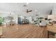 Open-concept living space with hardwood floors, modern kitchen, and comfortable seating area at 8701 E Sage Dr, Scottsdale, AZ 85250