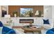 Cozy living room featuring modern fireplace, custom built-ins, and stylish furnishings at 8701 E Sage Dr, Scottsdale, AZ 85250