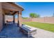 This backyard features low maintenance turf grass, a stone firepit, and a covered patio at 900 E Harrison St, Chandler, AZ 85225