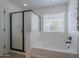 Bathroom featuring a tub, shower, and window with modern fixtures and bright light at 900 E Harrison St, Chandler, AZ 85225