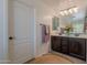 Bathroom featuring a double vanity with dark cabinets, and neutral-colored accessories at 900 E Harrison St, Chandler, AZ 85225