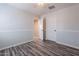 A vacant bedroom features wood-look floors and a door to another room at 900 E Harrison St, Chandler, AZ 85225