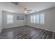 Bedroom features wood-look floors, a ceiling fan, and shuttered windows at 900 E Harrison St, Chandler, AZ 85225
