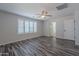 Bedroom with wood-look floors, ceiling fan, shuttered windows, and an open doorway at 900 E Harrison St, Chandler, AZ 85225