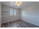 This bedroom features neutral paint, wood-look floors, and natural light from the window at 900 E Harrison St, Chandler, AZ 85225