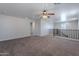 Large bonus room with carpet, ceiling fan, and ample natural light from windows at 900 E Harrison St, Chandler, AZ 85225