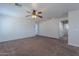 Open bonus room with neutral carpet, ceiling fan, and doorway access to other rooms at 900 E Harrison St, Chandler, AZ 85225