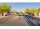Black, gated community entrance with stone pillars and well-maintained landscaping at 900 E Harrison St, Chandler, AZ 85225