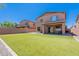 Beautiful backyard features lush artificial turf, a covered patio, and cozy outdoor fire pit at 900 E Harrison St, Chandler, AZ 85225