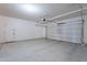 Three car garage with neutral paint, overhead lighting, and access door at 900 E Harrison St, Chandler, AZ 85225