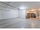 Spacious three car garage with overhead lighting, storage shelving, and epoxy flooring at 900 E Harrison St, Chandler, AZ 85225