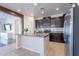 Spacious kitchen island featuring stainless steel appliances, dark cabinets, and tile flooring throughout at 900 E Harrison St, Chandler, AZ 85225