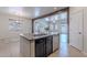 Kitchen island featuring a stainless steel sink, granite countertops, and sightlines to the living room at 900 E Harrison St, Chandler, AZ 85225