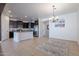 Open-concept kitchen featuring dark cabinets, stainless steel appliances, and tile flooring throughout the space at 900 E Harrison St, Chandler, AZ 85225