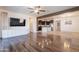 Open-concept living room view to modern kitchen; features ceiling fan and hardwood floors at 900 E Harrison St, Chandler, AZ 85225