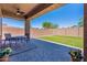 Covered patio includes ceiling fans and paver flooring, overlooking a lush turf backyard at 900 E Harrison St, Chandler, AZ 85225