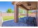 Inviting covered patio features ceiling fans and overlooks the green backyard with a block fence at 900 E Harrison St, Chandler, AZ 85225
