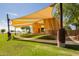 Outdoor amphitheater with unique shade canopies, set against a backdrop of mature trees at 9764 E Radioactive Dr, Mesa, AZ 85212